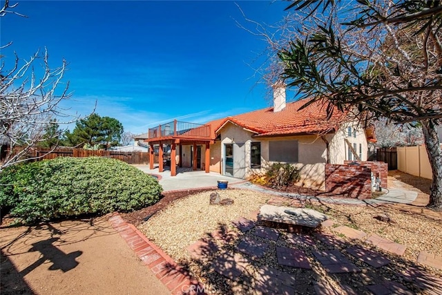 back of house featuring a patio area, stucco siding, a tiled roof, and a fenced backyard