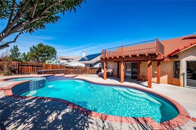 view of pool with a patio area, a deck, a pool with connected hot tub, and a fenced backyard