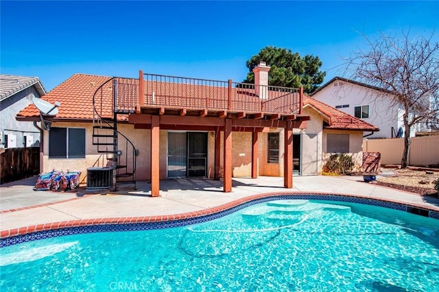 view of swimming pool with a patio, central air condition unit, fence, and a fenced in pool