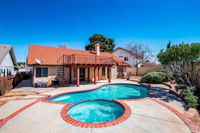 view of swimming pool with central AC, a pool with connected hot tub, a fenced backyard, and a patio area