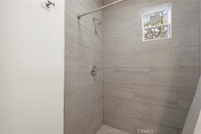 bathroom with tiled shower