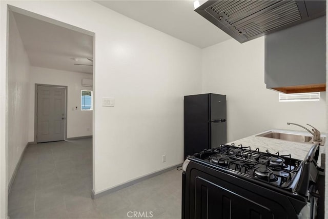 kitchen featuring black appliances, exhaust hood, baseboards, and a sink