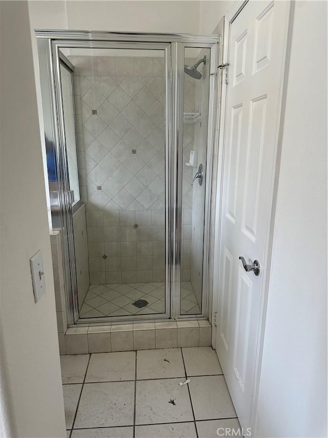 full bathroom with tile patterned floors and a shower stall