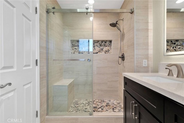 bathroom with vanity and a shower stall