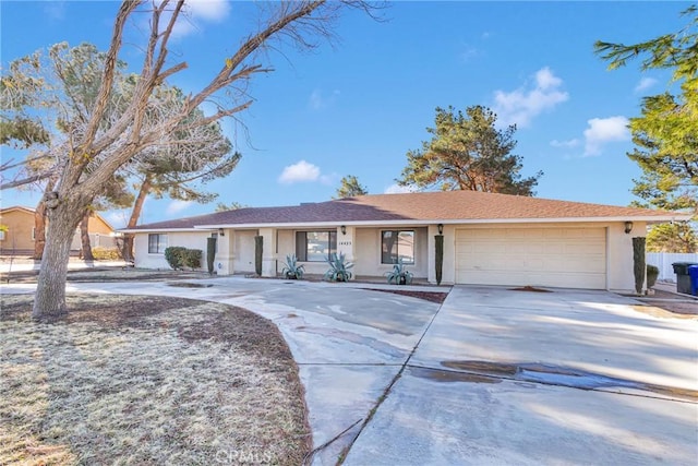 single story home featuring concrete driveway, fence, a garage, and stucco siding