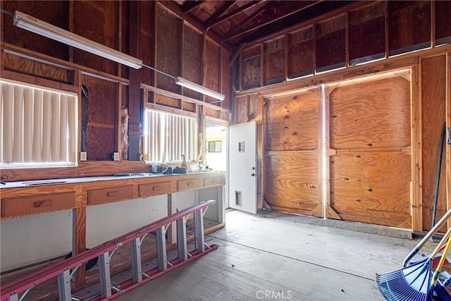 miscellaneous room with high vaulted ceiling