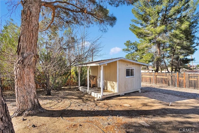 view of shed featuring fence