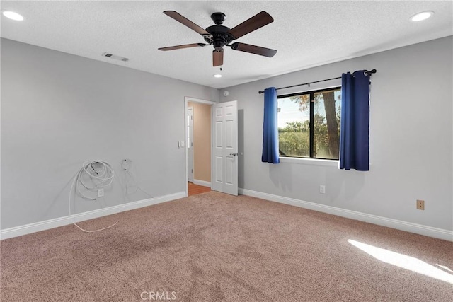 carpeted empty room with visible vents, baseboards, recessed lighting, a textured ceiling, and a ceiling fan