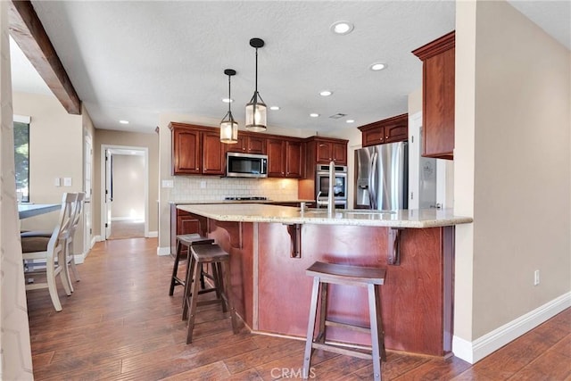 kitchen with tasteful backsplash, light stone counters, a peninsula, light wood-style floors, and stainless steel appliances