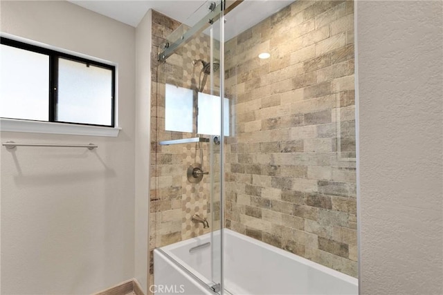 full bath with plenty of natural light and combined bath / shower with glass door