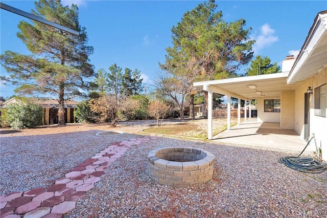 view of yard featuring a patio, an outdoor fire pit, and a fenced backyard