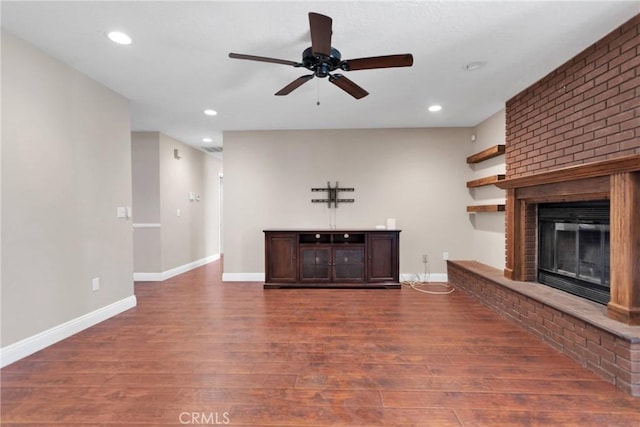 unfurnished living room with recessed lighting, a fireplace, baseboards, and wood finished floors