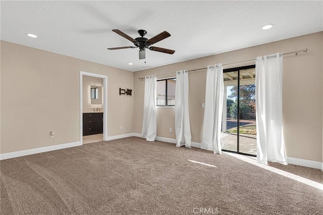 unfurnished bedroom featuring access to exterior, baseboards, carpet flooring, recessed lighting, and a textured ceiling