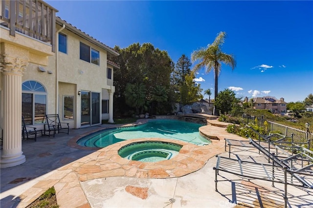 view of swimming pool featuring a patio area, a fenced in pool, an in ground hot tub, and fence