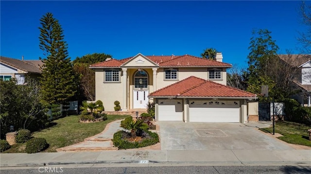 mediterranean / spanish-style house with a garage, concrete driveway, stucco siding, and a tile roof