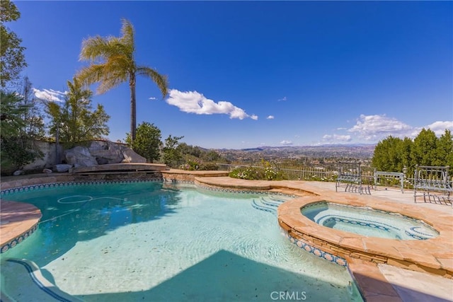 view of pool with a fenced in pool, a patio area, an in ground hot tub, and fence