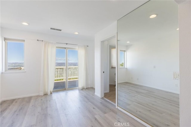 unfurnished bedroom featuring access to outside, recessed lighting, visible vents, and light wood finished floors