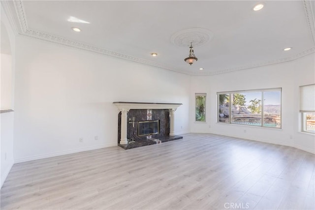 unfurnished living room with baseboards, wood finished floors, and a fireplace