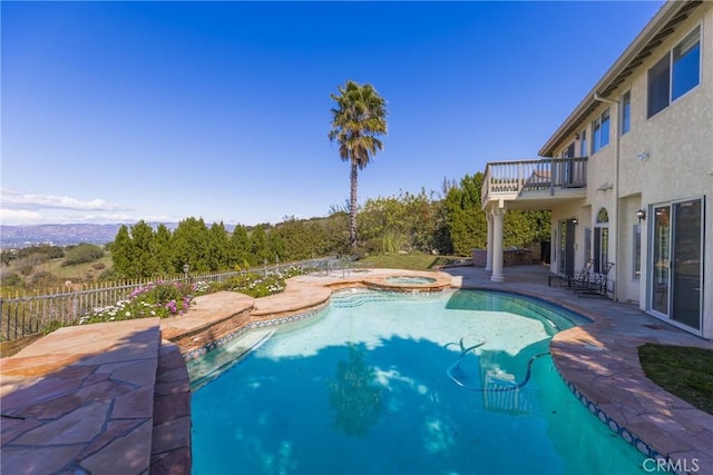 view of swimming pool with an in ground hot tub, a fenced in pool, and a patio area