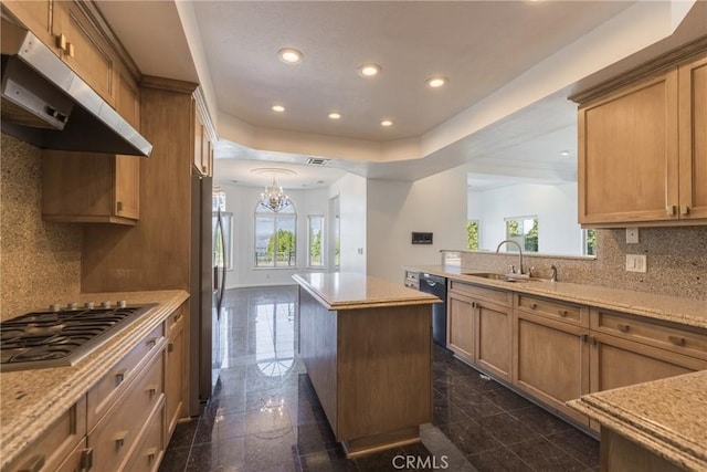 kitchen featuring under cabinet range hood, a sink, granite finish floor, recessed lighting, and appliances with stainless steel finishes