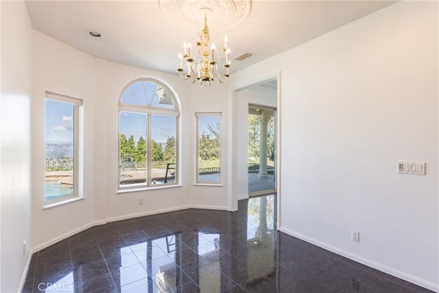 unfurnished room with an inviting chandelier, granite finish floor, visible vents, and baseboards