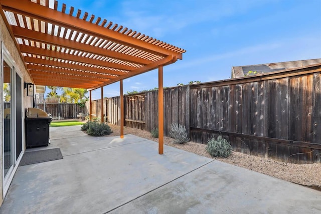 view of patio with grilling area, a pergola, and a fenced backyard