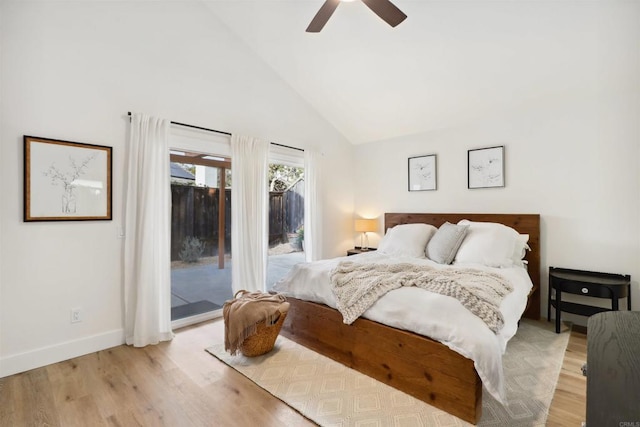 bedroom with high vaulted ceiling, access to outside, light wood-style floors, baseboards, and ceiling fan