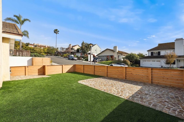 view of yard featuring fence and a residential view