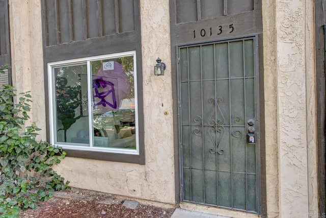 property entrance with stucco siding