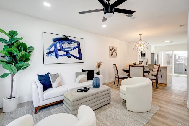 living area with recessed lighting, light wood-style floors, and ceiling fan