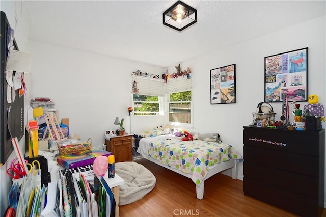 bedroom featuring wood finished floors