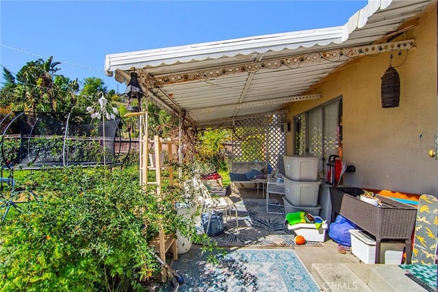 view of patio / terrace featuring a trampoline and fence