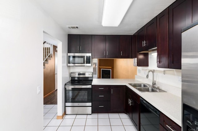 kitchen featuring light tile patterned floors, visible vents, a sink, light countertops, and appliances with stainless steel finishes