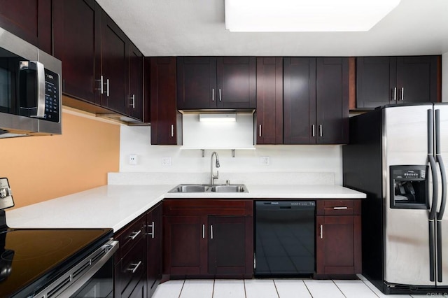 kitchen featuring a sink, appliances with stainless steel finishes, light tile patterned floors, and light countertops