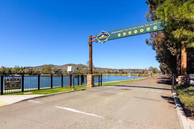 view of road featuring curbs and a water view