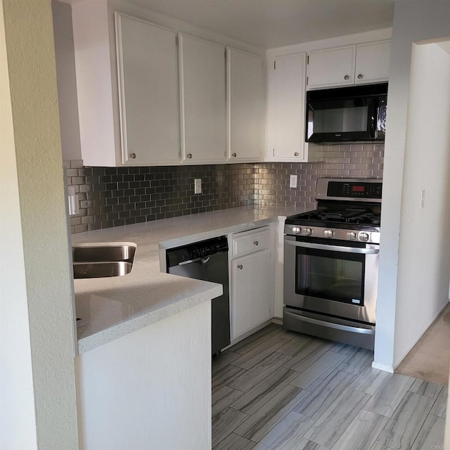 kitchen featuring dishwashing machine, stainless steel range with gas cooktop, light countertops, black microwave, and tasteful backsplash