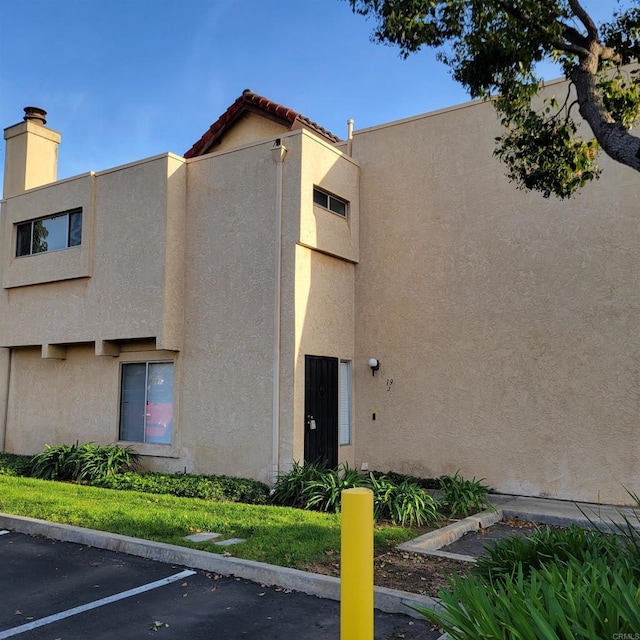 view of building exterior featuring uncovered parking