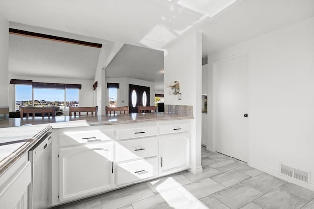 kitchen with stainless steel dishwasher, light countertops, visible vents, and white cabinetry