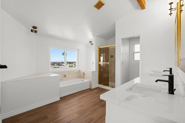 bathroom with visible vents, a garden tub, a stall shower, wood finished floors, and a sink