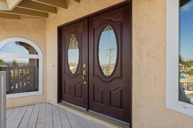 entrance to property with stucco siding