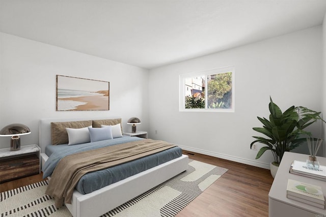 bedroom featuring baseboards and wood finished floors