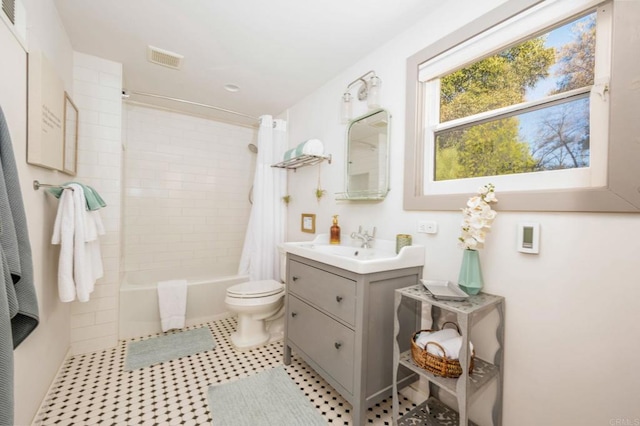 bathroom featuring visible vents, toilet, vanity, and shower / tub combo with curtain