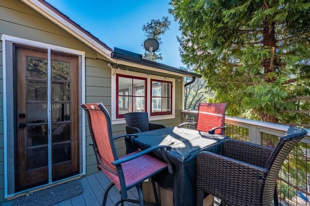 wooden deck with outdoor dining space