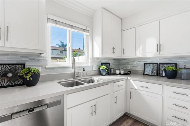 kitchen with a sink, white cabinets, decorative backsplash, and stainless steel dishwasher