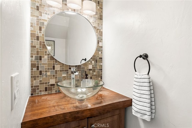 bathroom with tasteful backsplash and vanity