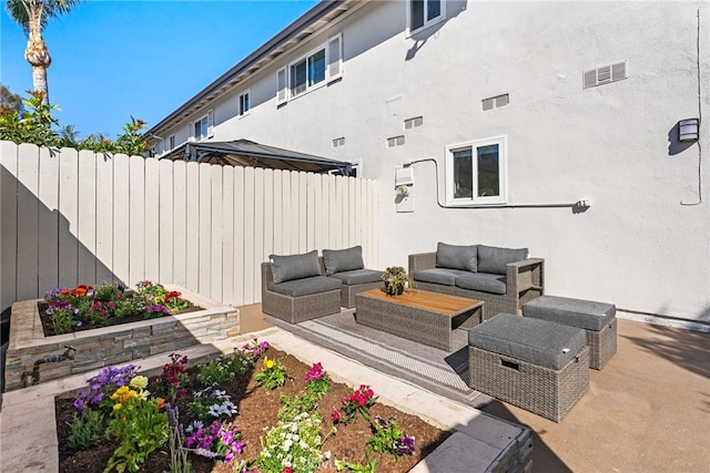 view of patio with visible vents, an outdoor hangout area, and a fenced backyard