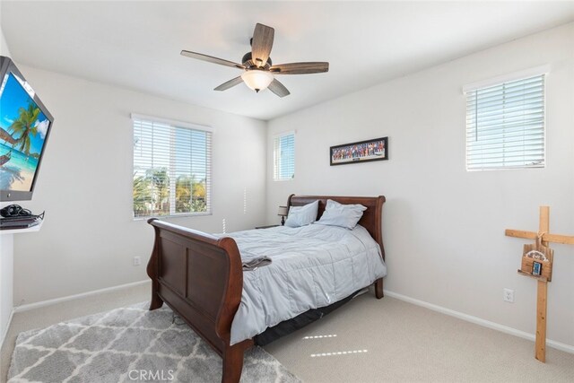 bedroom featuring baseboards, ceiling fan, and carpet flooring