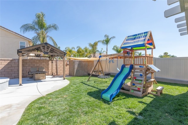 view of jungle gym with a yard, a patio area, and a fenced backyard