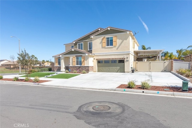 craftsman house with fence, concrete driveway, stucco siding, an attached garage, and a gate