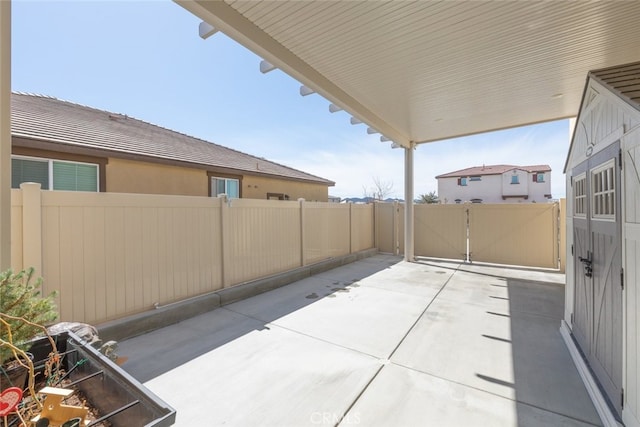 view of patio / terrace featuring fence and a gate